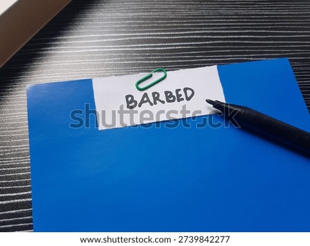 Barbed writting on table background. 