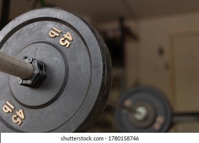 Barbell With 45lb Weights In A Home Gym