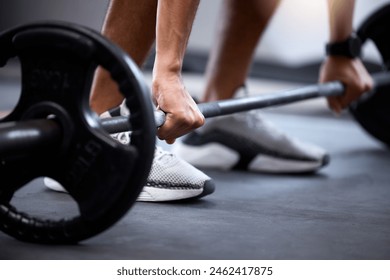 Barbell, fitness and strong hands of man in bodybuilder training for muscle power, legs challenge and workout. Sports, energy exercise and strong body builder in gym with feet zoom on floor or ground - Powered by Shutterstock