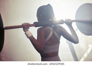 Barbell, gym and woman for workout and wellness, challenge and empowerment goal for body health. Athlete, training and Indian bodybuilder in fitness club for self care, squats for legs exercise - Powered by Shutterstock