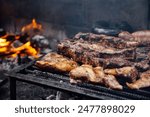 Barbeque, bbq meat cooking on grill. Traditional Asado of Argentina, Paraguay y Uruguay.