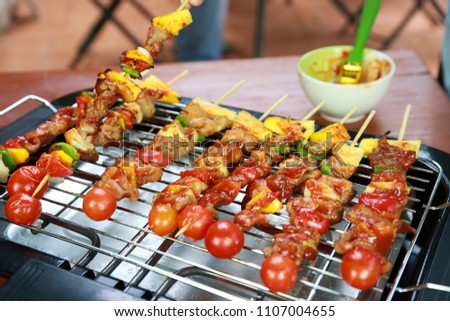 Barbeque Grill Street Food in thailand,Eat outdoors in a happy family.