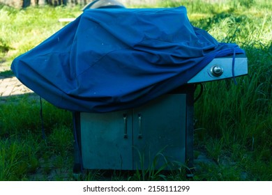 A Barbeque In An Overgrown Field