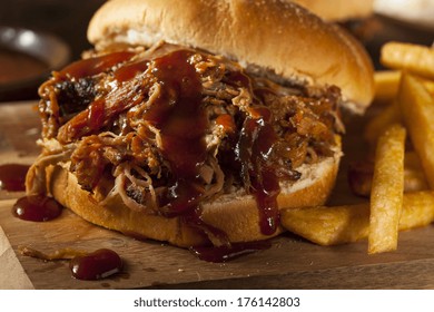 Barbeque Pulled Pork Sandwich With BBQ Sauce And Fries