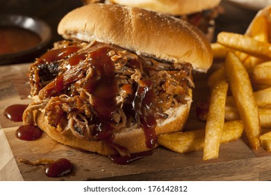 Barbeque Pulled Pork Sandwich with BBQ Sauce and Fries - Shutterstock ID 176142812
