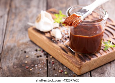 Barbeque sauce with a basting brush in a jar - Shutterstock ID 432677620