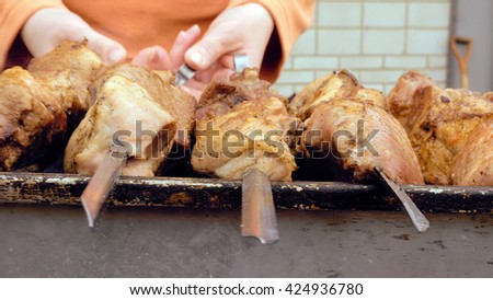 Barbeque skewers with meat cooking on hot coal ember brazier Outdoors picnic concept.