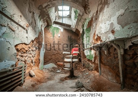 A Barber Chair In Empty Prison Cell at Eastern State Penitentiary, Prison in Philadelphia, Pennsylvania, USA