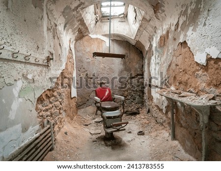 A Barber Chair In Empty Prison Cell at Eastern State Penitentiary, Prison in Philadelphia, Pennsylvania, USA