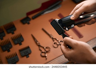 Barber cleaning hair clipper with brush after hair cutting - Powered by Shutterstock