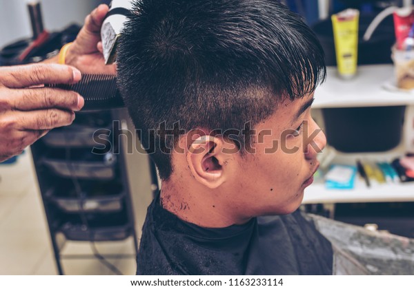 Barber Cutting Teenager Hair Clippermans Grooming Stock Photo