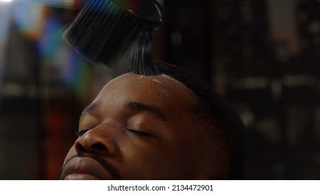 Barber Dusting An African American Guy's Forehead Before Shaving. Close-up