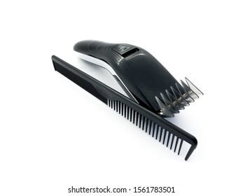 Barber hair clipper and black comb isolated on white background. Men's hairdresser tool. Set of hairdressing tools for a beauty salon. Typewriter and comb - Powered by Shutterstock