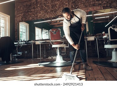 Barber, salon and man with broom for cleaning after grooming, shaving and hair cut for beauty service. Hygiene, workplace and hairdresser in barbershop sweeping for dirt, dust and mess on floor - Powered by Shutterstock