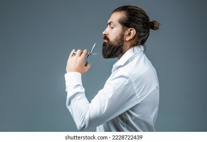 Barber scissors. Vintage barbershop, shaving. Male in barbershop, haircut, shaving. Bearded man isolated on gray background. Mans haircut in barber shop. Barber scissors, barber shop. - Shutterstock ID 2228722439