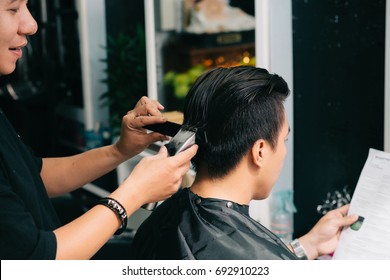 Barber shaving back of clients head - Powered by Shutterstock