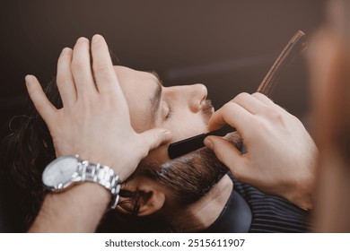 Barber shaving man with sharp steel razor, banner barbershop warm retro old toning. - Powered by Shutterstock