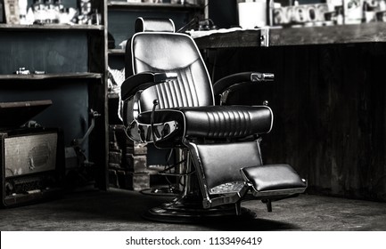 Barber shop chair. Stylish vintage barber chair. Barbershop armchair, modern hairdresser and hair salon, barber shop for men. Barbershop theme. Hairstylist in barber shop interior. Black and white.