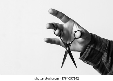 Barber shop. Barber hand holding scissors. Barber professional tools. Male haircut, fashion. Barbershop, haircut and shaving background. Small business. Background with copy space.