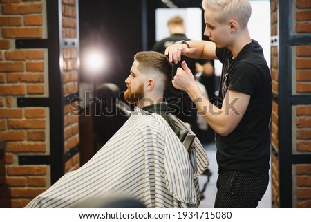 Similar – Image, Stock Photo Hair style, hairdresser, beauty and customer service concept. Cropped shot of barber man hands hold professional stylish gold hairbrush and scissors by the workplace, leather black chair in barbershop