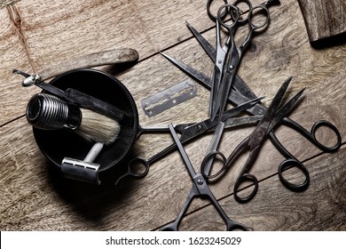 Barber shop vintage equipment tools Brush Razor Hair Trimmer Old used metal scissors Man hairdresser from the past Man hair stylist Beard trimming Metal parts on wooden background Steel and iron pi