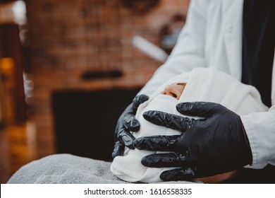 Barber steam face skin of man with hot towel before royal shave in Barbershop. - Powered by Shutterstock