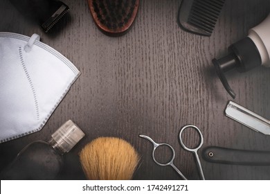 Barber Tools On Wood Dark Background,scissor,razor,brush,barber Machine,black Comb,soap Dispenser, Protective Face Mask And Sanitizer Alcohol Gel.