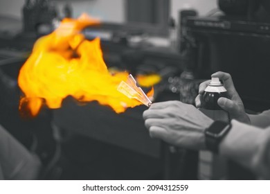 Barber Treats The Straight Razor With Antiseptic And Spray Fire. Black And White Image With Bright Orange Flames. Shallow Depth Of Field. Vintage Style Barbershop Concept