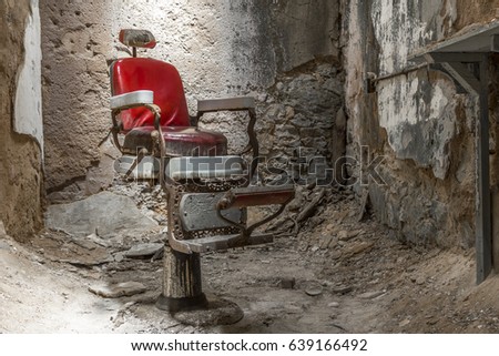 Barber's chair in a cell in an abandoned prison