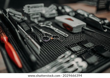 Barbershop.The atmosphere in the barbershop. men's hairdresser. Scissors and razor. Scissors in hand. Shaving blade.