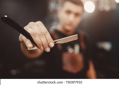 Barbershop. Close-up Of Barber Holds Razor For Shaving His Beard