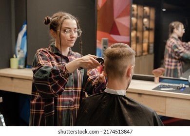 Barbershop, Close-up: A Woman Hairdresser Cuts Hair With A Razor