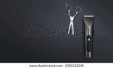 Barbershop concept. Hair clipper and Hairdresser scissors on black background top view space for text. Hair extensions, materials and cosmetics, hair care, wig. Hairstyle, haircut in salon