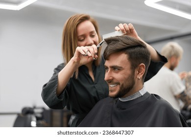 Barbershop. Female hair stylist and male customer - Powered by Shutterstock