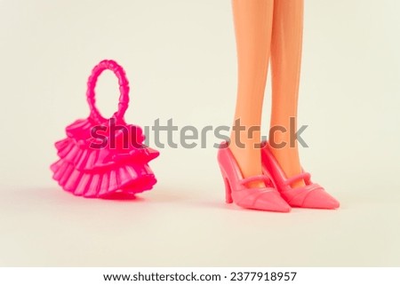 Barbie doll in a pink dress on a white background. various accessories for playing with a doll.