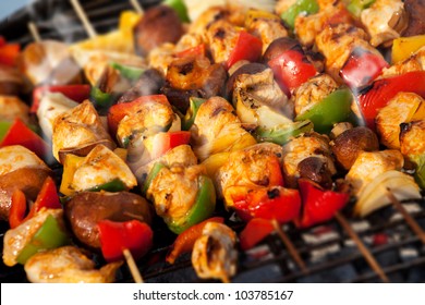 Bar-B-Q Or BBQ With Kebab Cooking. Coal Grill Of Chicken Meat Skewers With Mushroom And Peppers. Barbecuing Dinner