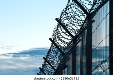 BARBWIRE FENCE AT THE STATE BORDER, BARBED WALL BACKGROUND