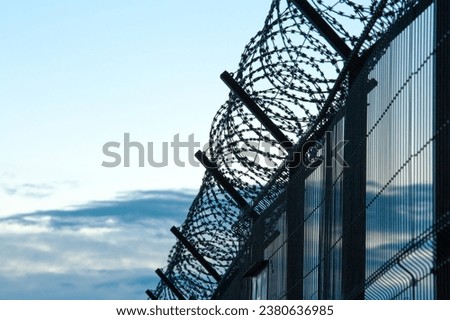 BARBWIRE FENCE AT THE STATE BORDER, BARBED WALL BACKGROUND