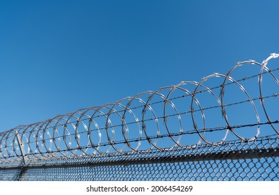 barbwire perimeter fence. ensuring safety and security. jail wall.