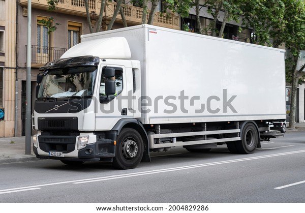 Barcelona, ​​Spain; April 8,\
2021: Large delivery truck parked on the street. It\'s a white Volvo\
FE 320
