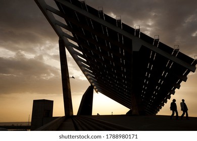 Barcelona, Catalonia, Spain -03 Apr 2011- Two People Walking Under The Giant Solar Pannel At The Forum Area