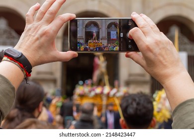 Barcelona, Catalonia, Spain - April 10, 2022. Man Taking A Photo With His Cell Phone At The Passage Of The Borriquita In Barcelona (Spain), Selective Focus On The Cell Phone.