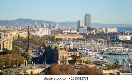 Barcelona, Catalonia / Spain - January 1, 2019: Long shot of the waterfront area of the city, with the Columbus Monument in the foreground