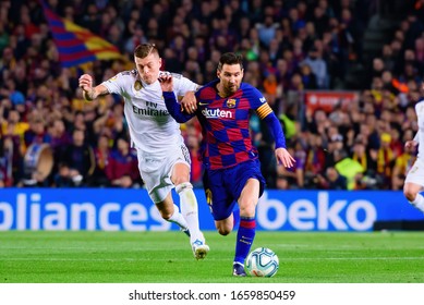 BARCELONA - DEC 18: Kroos (L) and Messi (R) play at the La Liga match between FC Barcelona and Real Madrid at the Camp Nou Stadium on December 18, 2019 in Barcelona, Spain.