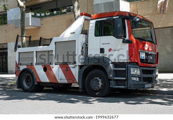 Barcelona, ​​Spain; June 20, 2021: Crane truck to\
tow trucks and buses. It\'s a MAN\
TGS