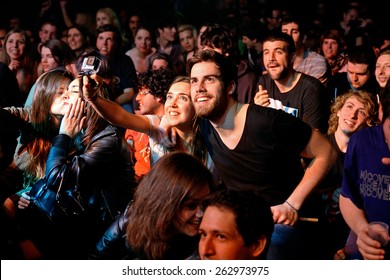 BARCELONA - MAR 18: A Couple From The Crowd Takes A Selfie With A Gopro Camera At Bikini Stage On March 18, 2015 In Barcelona, Spain.