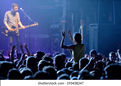 BARCELONA - MAY 16: A Girl (fan) From The Audience Clapping And Screaming In Front Of His Favourite Guitarist In A Concert At Razzmatazz Discotheque On May 16, 2014 In Barcelona, Spain.