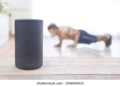 BARCELONA, OCTOBER 31: Man Doing Some Pushup Workout At Home With An Alexa Echo Plus Fitness Skill On October 31, 2019