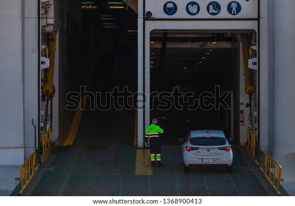 Barcelona / Spain 04 04 2019: Car drives\
into the ferry. Car transportation in cargo ships.\
