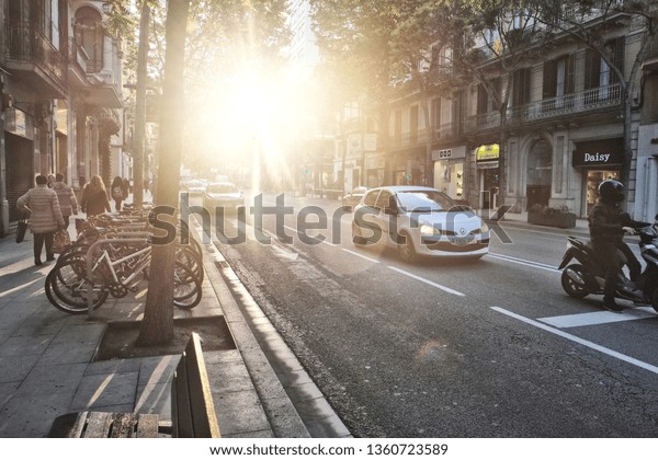 Barcelona, Spain - 04.27.2017: A street at\
sundown in cozy\
Barcelona